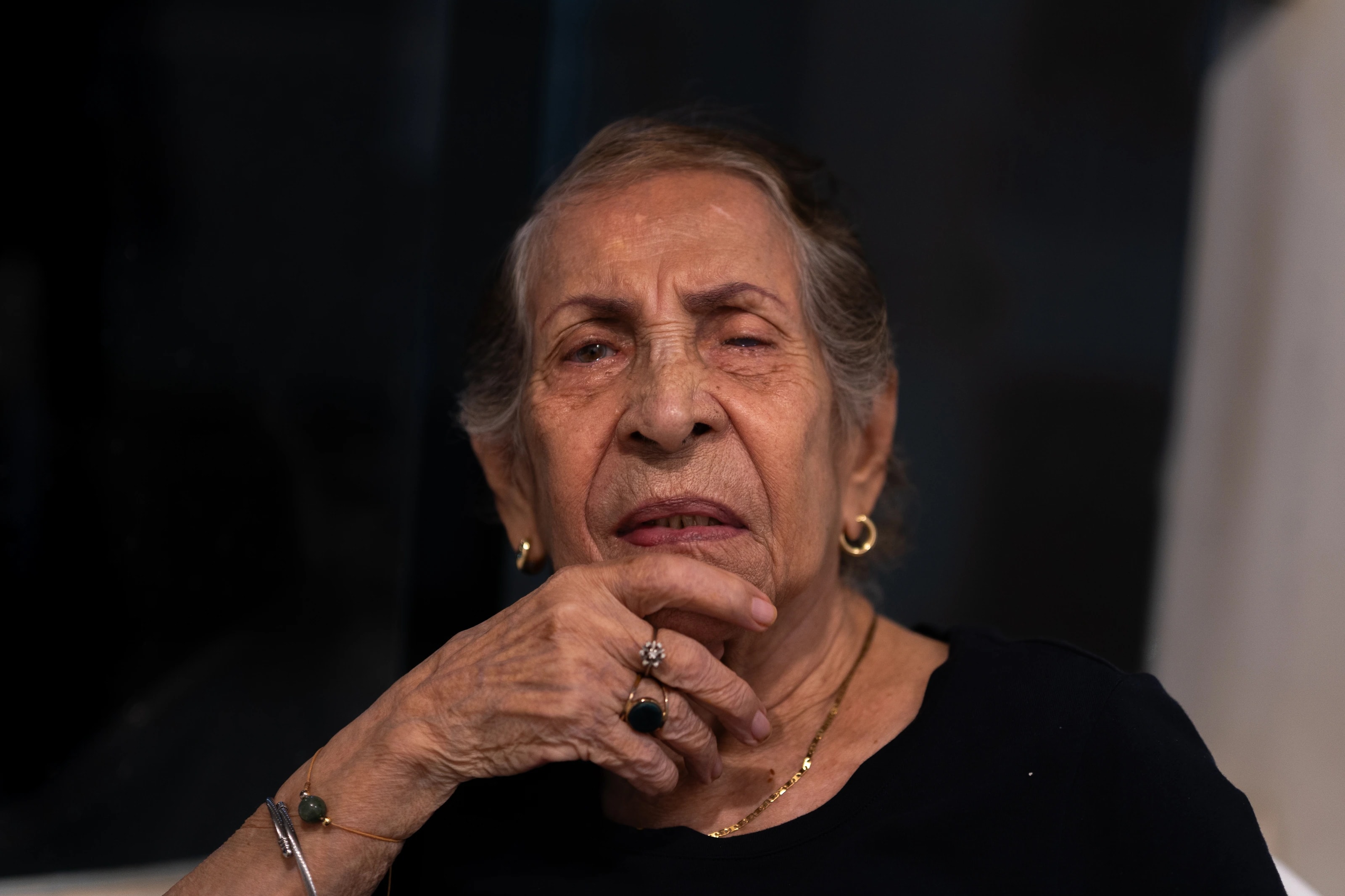Portrait of a woman with her hand resting against her face