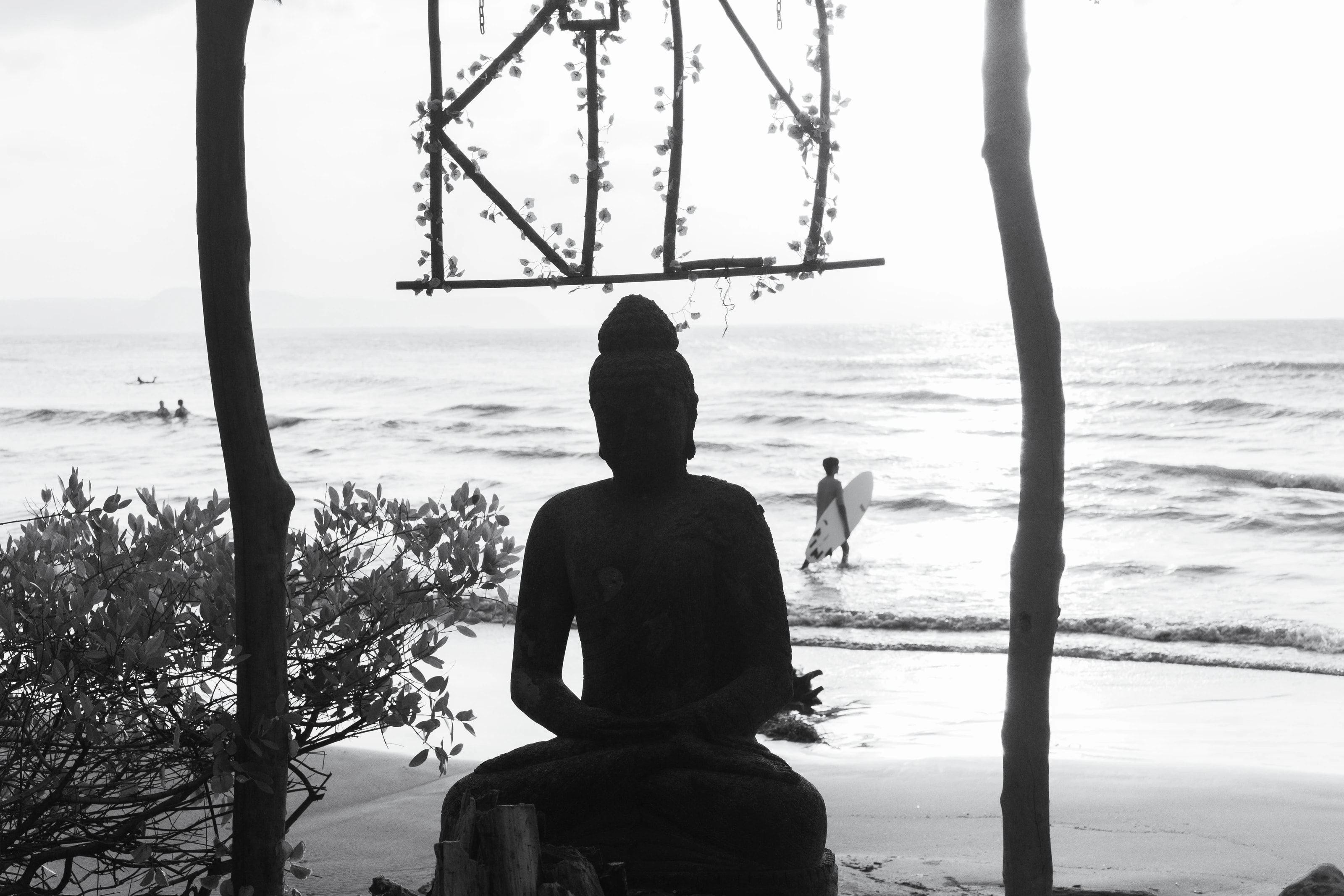 A seated figure facing the sea
