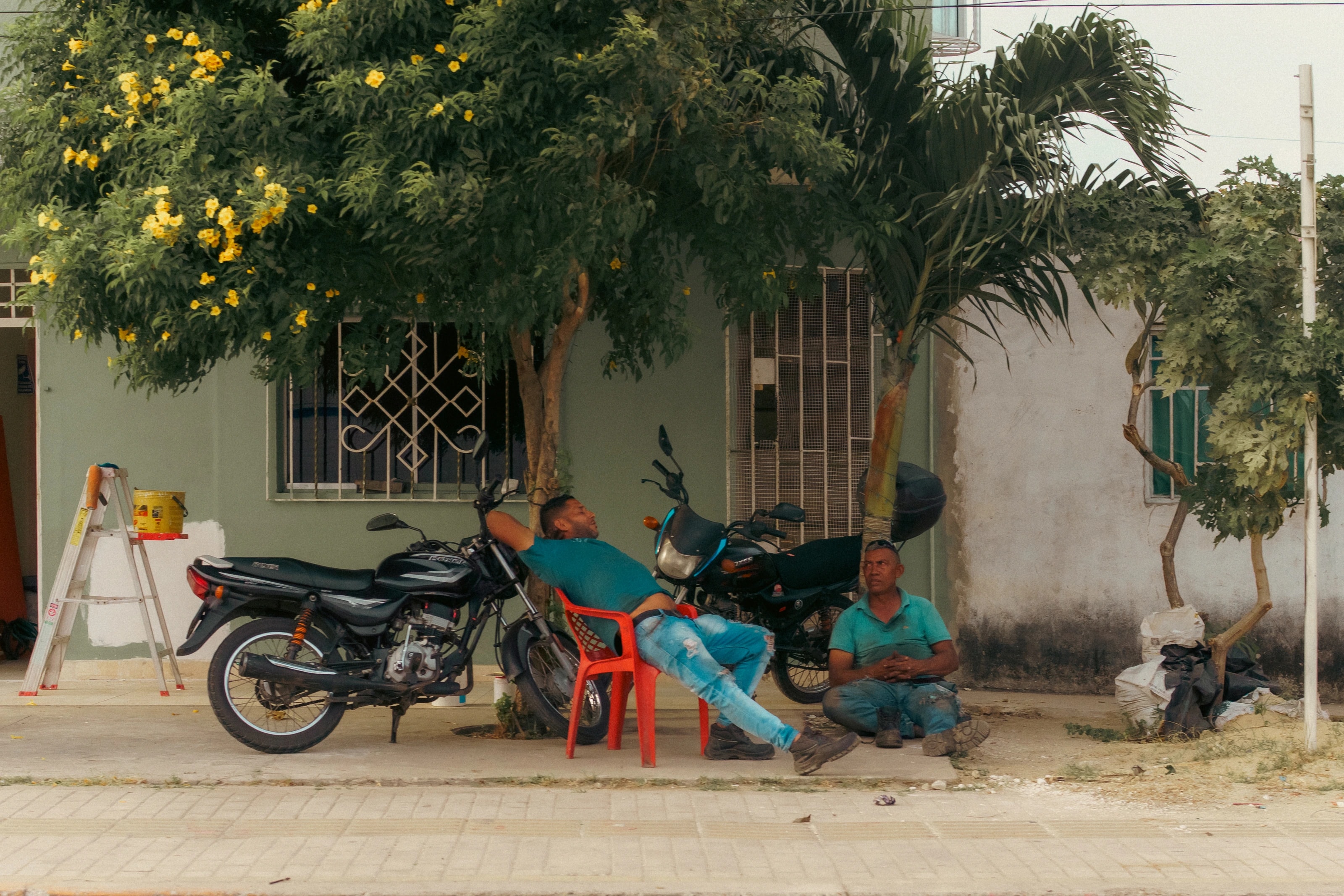 Motorbikes parked on a shaded street