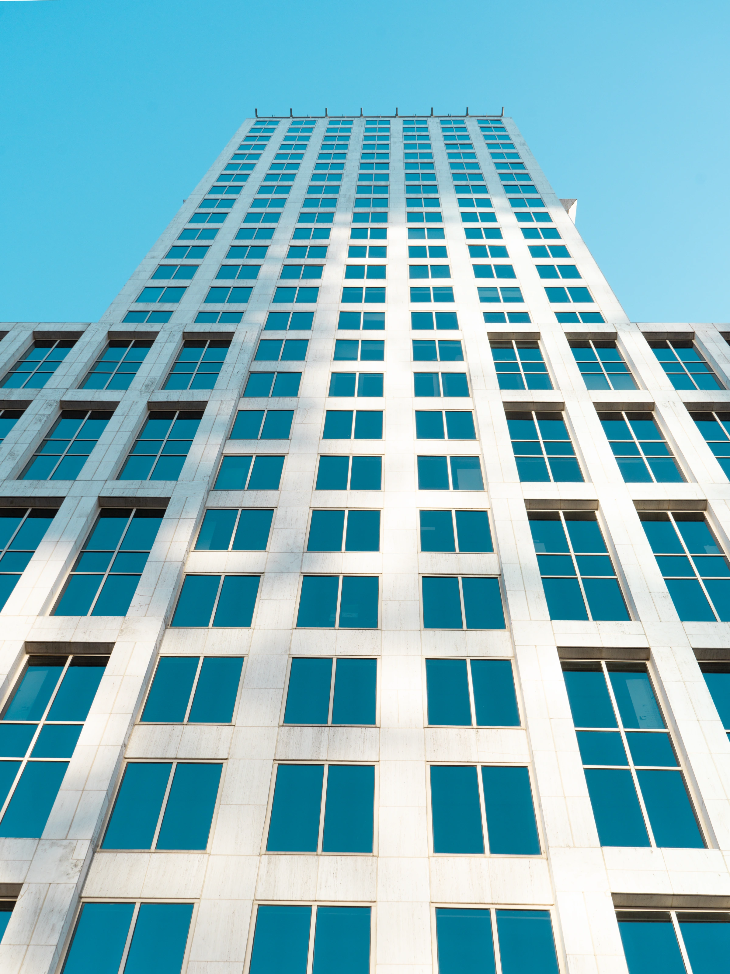 A tall white building against a blue sky