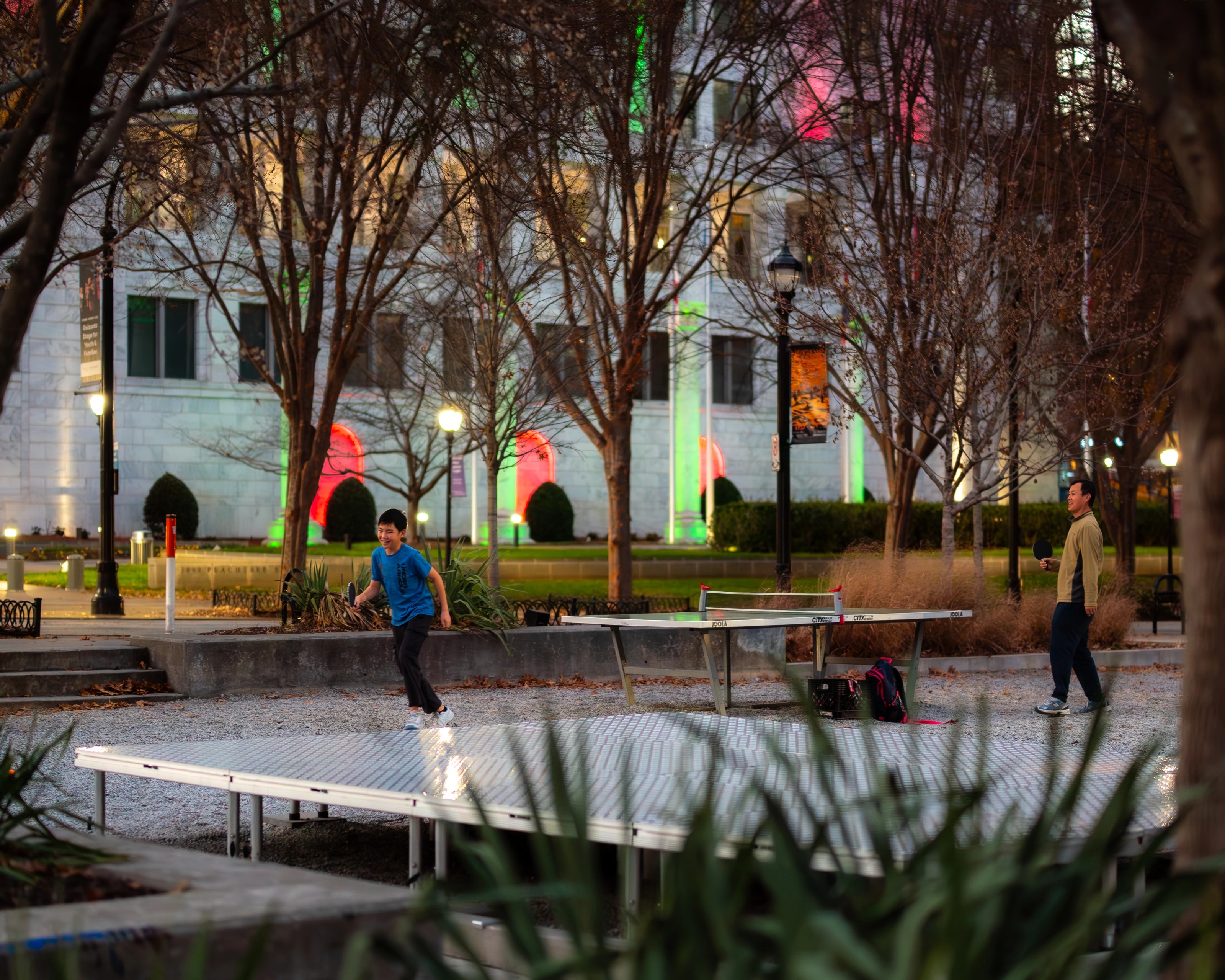 People moving through a park with colorful installations