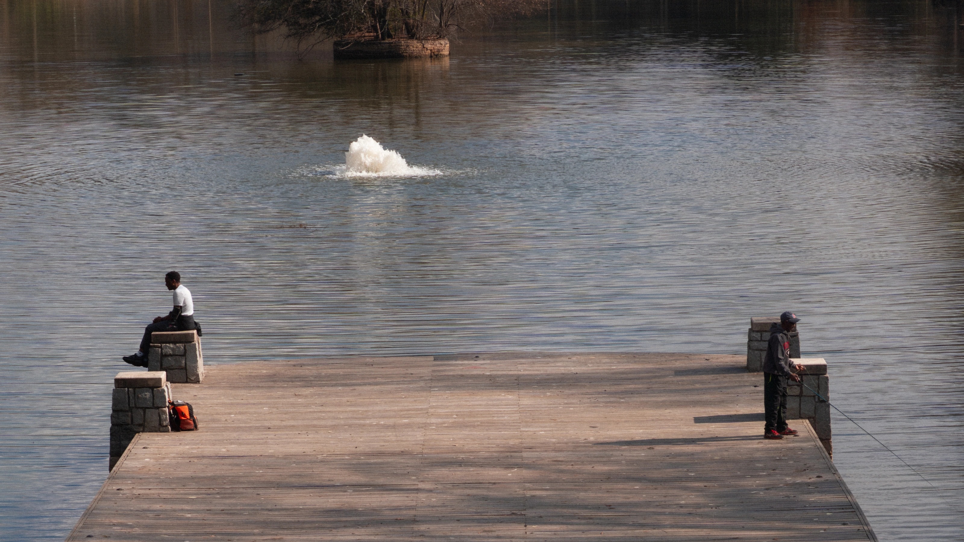 A wooden pier extending into still water