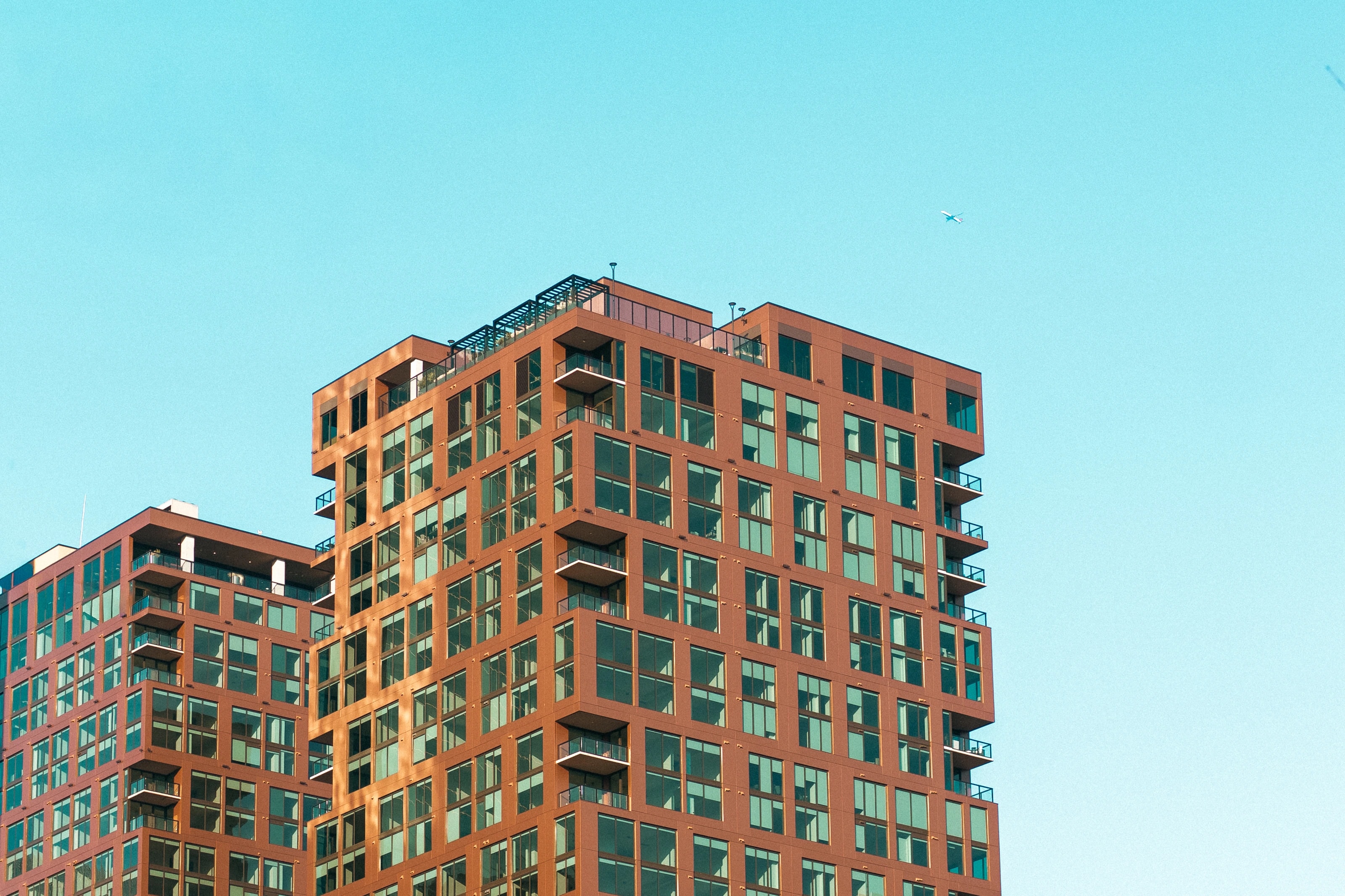 Brick apartment buildings against a clear blue sky