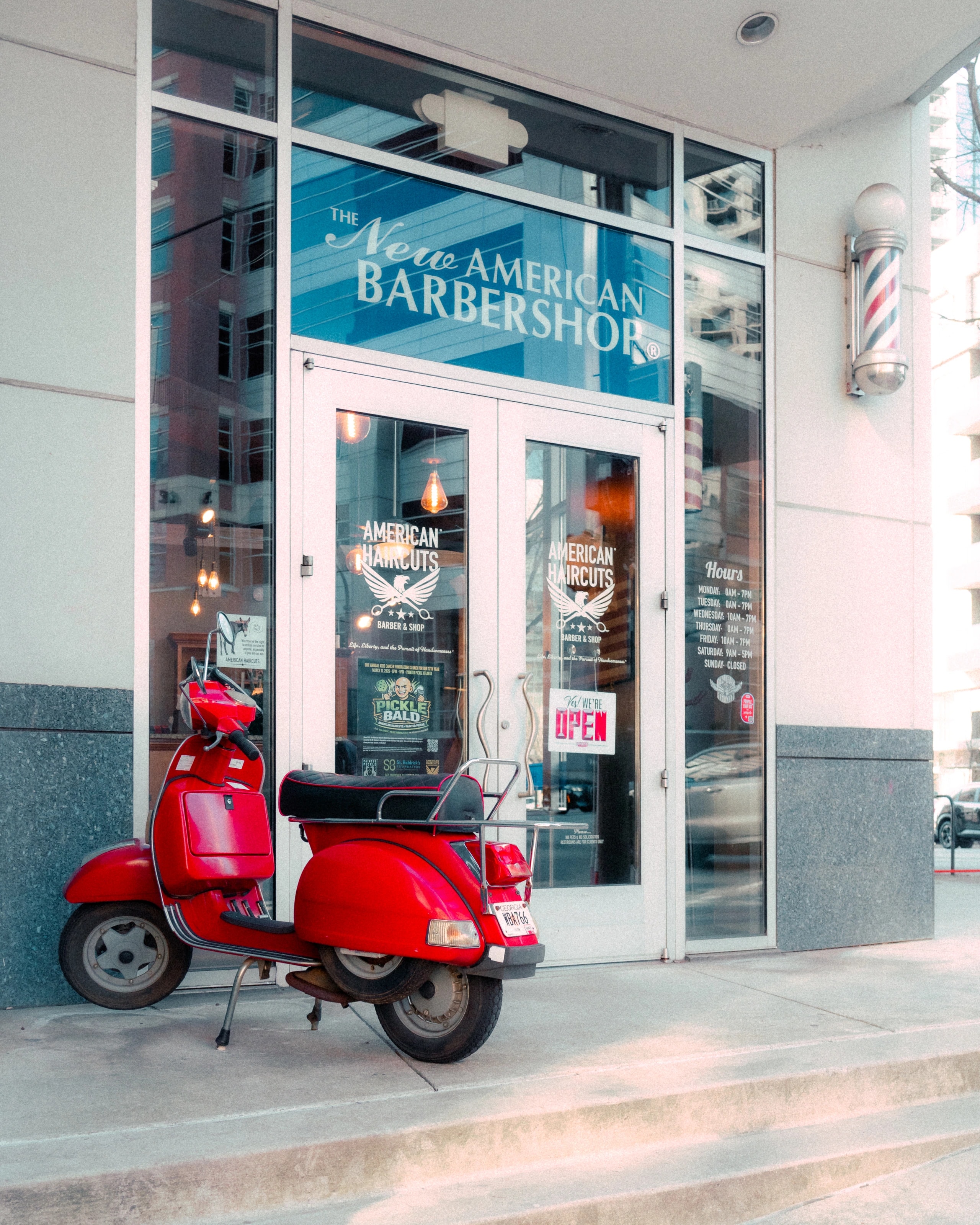 A red scooter outside a shop